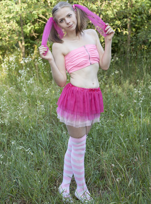 18 year old girl Megan Rain removes her sandals and then clothes to pose naked